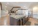 Spacious kitchen and living room with large island, stainless steel appliances, and hardwood floors at 2418 Claude Brewer Rd, Loganville, GA 30052