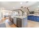 Open-concept kitchen with stainless steel appliances, large island, and seamlessly connected living spaces at 2418 Claude Brewer Rd, Loganville, GA 30052