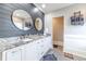Elegant main bathroom with double vanity, granite countertop, modern fixtures, and decorative mirrors at 2418 Claude Brewer Rd, Loganville, GA 30052