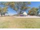Back of the home, set on a well-manicured lawn, featuring an extra long driveway and detached garage at 2418 Claude Brewer Rd, Loganville, GA 30052
