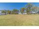 Spacious lawn and mature trees showcasing the home, outbuilding, and expansive property at 2418 Claude Brewer Rd, Loganville, GA 30052