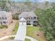 Stunning aerial view of the brick home showcasing its manicured lawn, driveway, and two-car garage at 2784 Hilson Commons, Decatur, GA 30034