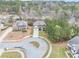 Aerial view of the brick home with a landscaped lawn, two-car garage, and a cul-de-sac at 2784 Hilson Commons, Decatur, GA 30034