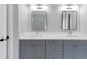 Bathroom with gray cabinets, double sinks, and black framed mirrors at 2784 Hilson Commons, Decatur, GA 30034