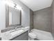 This bathroom offers a framed mirror, granite countertop, grey cabinets, and a shower and tub combination at 2784 Hilson Commons, Decatur, GA 30034