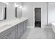 Bathroom with gray cabinets, marble floors, double sinks, and a walk-in closet at 2784 Hilson Commons, Decatur, GA 30034