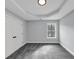 Bedroom featuring soft grey walls, grey carpet, a geometric trey ceiling and a closet with doors at 2784 Hilson Commons, Decatur, GA 30034