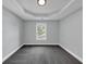 Empty bedroom exhibiting soft grey walls, grey carpet and a geometric trey ceiling with a view of a window at 2784 Hilson Commons, Decatur, GA 30034