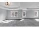 Spacious bedroom featuring gray carpet, tray ceiling, and three large windows at 2784 Hilson Commons, Decatur, GA 30034