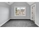 This spacious bedroom features plush carpet, neutral walls, and a view of the neighborhood at 2784 Hilson Commons, Decatur, GA 30034