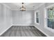 Bright, carpeted room with crown molding, a modern light fixture, and large windows offering serene views at 2784 Hilson Commons, Decatur, GA 30034