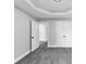 Bedroom with soft grey walls, grey carpet, a geometric trey ceiling and closet at 2784 Hilson Commons, Decatur, GA 30034