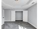 Bedroom featuring soft grey walls, grey carpet, geometric trey ceiling and open closet at 2784 Hilson Commons, Decatur, GA 30034
