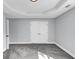 Bedroom with soft grey walls, grey carpet, a geometric trey ceiling and a closet with doors at 2784 Hilson Commons, Decatur, GA 30034