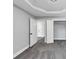 Bedroom featuring soft grey walls, grey carpet, a geometric trey ceiling and an open closet at 2784 Hilson Commons, Decatur, GA 30034