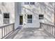 A view of the home's deck, with railing, white siding, and door, is ideal for outdoor living at 2784 Hilson Commons, Decatur, GA 30034