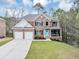 Charming brick two-story home featuring an attached two-car garage and a bright blue front door at 2784 Hilson Commons, Decatur, GA 30034