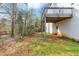 A view of the home's wooden deck, white siding, and door, overlooks a large yard at 2784 Hilson Commons, Decatur, GA 30034