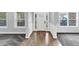 Inviting foyer featuring hardwood floors transitioning to carpet, complemented by elegant trim and ample natural light at 2784 Hilson Commons, Decatur, GA 30034