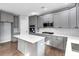 Modern kitchen with gray cabinets, a center island, and stainless steel appliances at 2784 Hilson Commons, Decatur, GA 30034