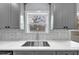 A modern kitchen sink with gray cabinets, countertops, and a white tile backsplash at 2784 Hilson Commons, Decatur, GA 30034