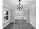Elegant living room with carpet, crown molding, and modern light fixture, open to adjacent rooms at 2784 Hilson Commons, Decatur, GA 30034