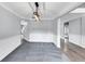 Spacious carpeted living room with chair rail, crown molding, and a modern light fixture with a partial view of foyer at 2784 Hilson Commons, Decatur, GA 30034