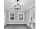 Inviting carpeted room with large windows, modern light fixture, and a view of an adjacent room at 2784 Hilson Commons, Decatur, GA 30034