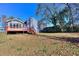 Large backyard with deck and partial view of the house, ideal for enjoying outdoor living and entertaining guests at 4185 Duesenberg Dr, Tucker, GA 30084