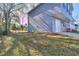 Split-level home showcasing the backyard with trees and a partial view of the exterior siding at 4185 Duesenberg Dr, Tucker, GA 30084