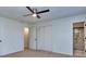 Spacious bedroom with ceiling fan, ample closet space, and an ensuite bathroom at 4185 Duesenberg Dr, Tucker, GA 30084