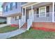 Split-level home featuring a gray exterior, a driveway, and a covered front porch with railing at 4185 Duesenberg Dr, Tucker, GA 30084