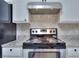 The updated kitchen features a new stainless steel stove and granite counter tops at 4185 Duesenberg Dr, Tucker, GA 30084