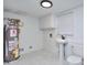 Clean and functional laundry room features a sink, toilet, cabinets and water heater at 4185 Duesenberg Dr, Tucker, GA 30084