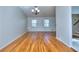 Spacious Living Room with hardwood floors, two windows, and chandelier-style light fixture at 4185 Duesenberg Dr, Tucker, GA 30084