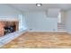 Cozy living room features a brick fireplace and hardwood floors at 4185 Duesenberg Dr, Tucker, GA 30084