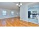 Open-concept living room featuring hardwood floors and a partial view into kitchen area at 4185 Duesenberg Dr, Tucker, GA 30084