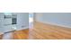Living room featuring hardwood floors and a partial view into kitchen area with stainless steel appliances at 4185 Duesenberg Dr, Tucker, GA 30084