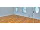 Bright living room featuring hardwood floors and ample natural light from windows and decorative front door at 4185 Duesenberg Dr, Tucker, GA 30084