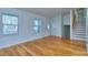 Bright living room featuring hardwood floors, staircase, and ample natural light from windows at 4185 Duesenberg Dr, Tucker, GA 30084
