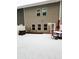 Backyard patio area with outdoor table and chairs in snowy conditions at 501 Crescent Woode Dr, Dallas, GA 30157