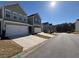 Street view of elegant townhomes, each with a two-car garage and manicured lawns in a serene neighborhood at 501 Crescent Woode Dr, Dallas, GA 30157