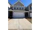 Charming townhome featuring a two-car garage, neutral siding, and well-manicured front yard at 501 Crescent Woode Dr, Dallas, GA 30157
