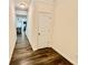 Hallway with faux wood flooring and view into a living space with a fireplace at 501 Crescent Woode Dr, Dallas, GA 30157