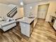 Well-designed kitchen flows into a living area, complemented by hardwood floors and a staircase at 501 Crescent Woode Dr, Dallas, GA 30157