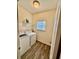 Bright laundry room featuring a washer, dryer, overhead storage, and window at 501 Crescent Woode Dr, Dallas, GA 30157