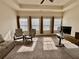 Inviting living room with plush carpet, tray ceiling, and bright natural light from several windows at 501 Crescent Woode Dr, Dallas, GA 30157