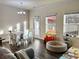 Cozy room featuring natural lighting from the backyard, a dining set, and wood flooring at 501 Crescent Woode Dr, Dallas, GA 30157