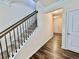 Elegant stairway featuring dark hardwood and carpeted steps, illuminated by modern recessed lighting at 501 Crescent Woode Dr, Dallas, GA 30157
