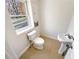 Half-bathroom with white fixtures and natural light at 156 Page Pl, Canton, GA 30114